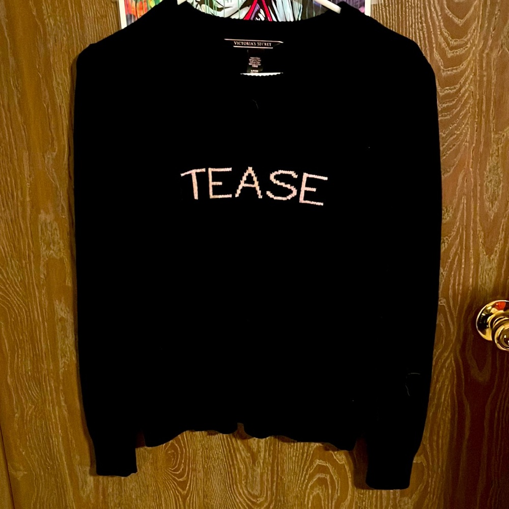 Victoria’s Secret sweater “tease” in pink writing black colored
